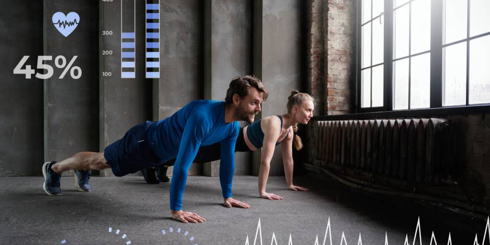 Image of a couple taking pushups inside a room and the vital readings displayed on the image.